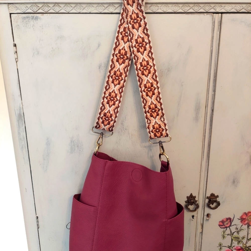 Crossbody purse with interchangeable strap.